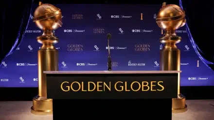 A sleek HD desktop wallpaper featuring the Golden Globe Awards stage, showcasing iconic golden globes flanking a podium with GOLDEN GLOBES prominently displayed.