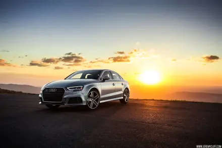 Silver Audi car parked on a coastal road at sunset with dramatic sky — HD PC desktop wallpaper/background