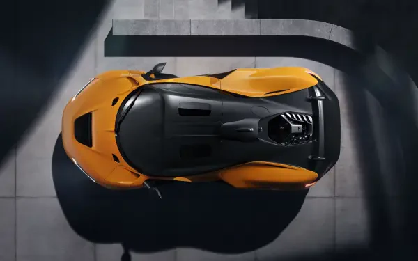 An overhead view of a McLaren W1, showcasing its sleek design and vibrant orange color against a modern architectural backdrop. This 8K Ultra HD image serves as a striking desktop wallpaper.