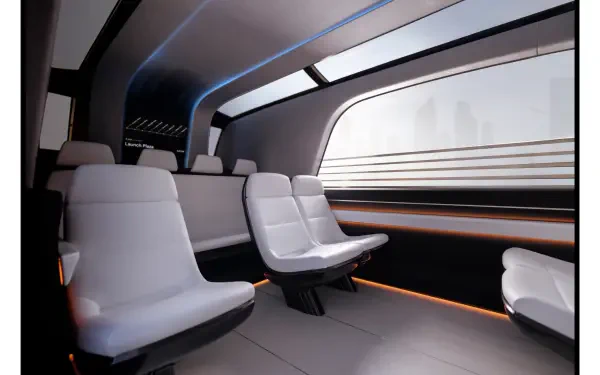 A sleek, modern interior of a Tesla robovan, showcasing spacious seating and ambient lighting. This 4K Ultra HD wallpaper captures futuristic design aesthetics.