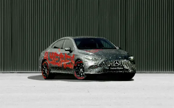 A sleek Mercedes-Benz CLA showcased with a striking camouflage design, set against a modern backdrop. This high-quality 4K Ultra HD image serves as a vibrant desktop wallpaper.
