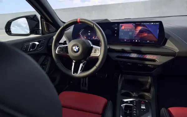 Interior view of a BMW M235 xDrive Gran Coupe, showcasing a sleek dashboard with a modern display and sporty seating, designed as a high-definition desktop wallpaper.