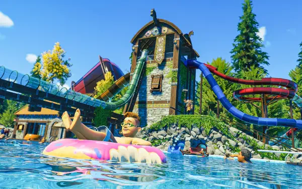 A vibrant scene from Planet Coaster 2, showcasing a water park with colorful slides and a kid enjoying a float in a sparkling blue pool under a clear sky.