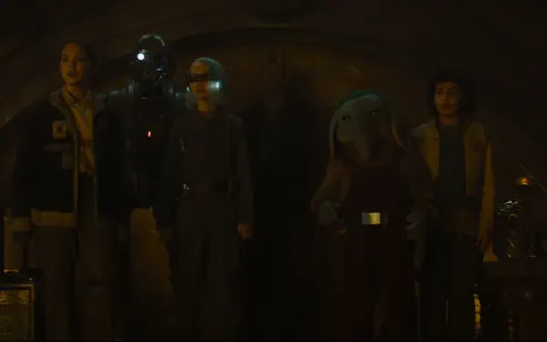 A group of characters from the TV show Star Wars: Skeleton Crew stands together in a dimly lit setting, creating an engaging HD desktop wallpaper and background.