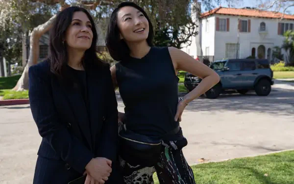 Abbi Jacobson and a companion smile while standing on a sunny street, captured in a vibrant scene from the TV show No Good Deed (2024). 4K Ultra HD wallpaper.