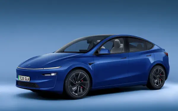 A sleek blue Tesla Model Y Juniper in a modern setting, featuring a stylish design and sharp lines, presented as a high-definition PC desktop wallpaper and background.