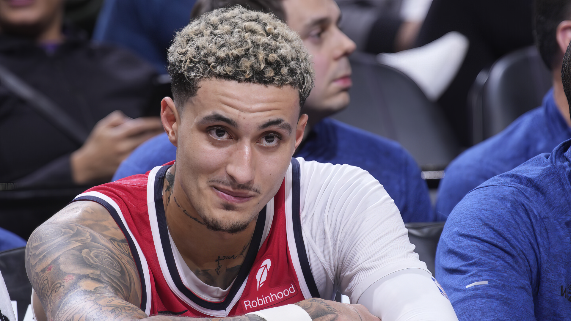 Kyle Kuzma of the Washington Wizards, captured during a game, showcases his confident smile in this HD basketball wallpaper. A vibrant moment from the NBA season.