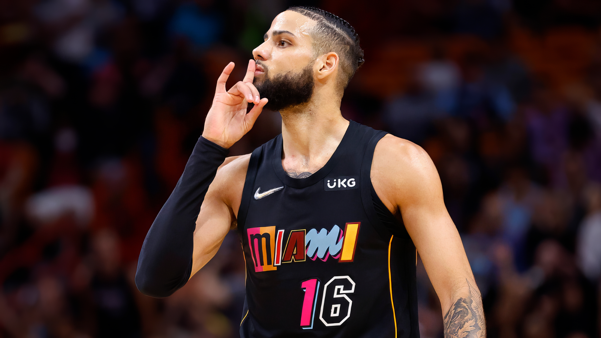 Caleb Martin of the Miami Heat gestures during an NBA game, showcasing his talent and passion for basketball in this dynamic HD wallpaper.
