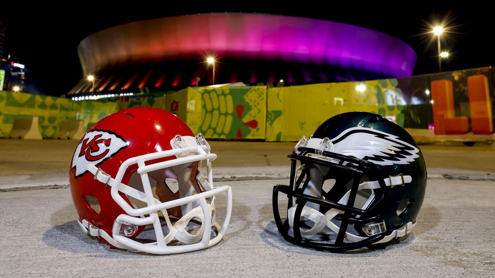 A vibrant HD wallpaper featuring Kansas City Chiefs and Philadelphia Eagles football helmets, set against a backdrop of an illuminated stadium, capturing the excitement of NFL sports.