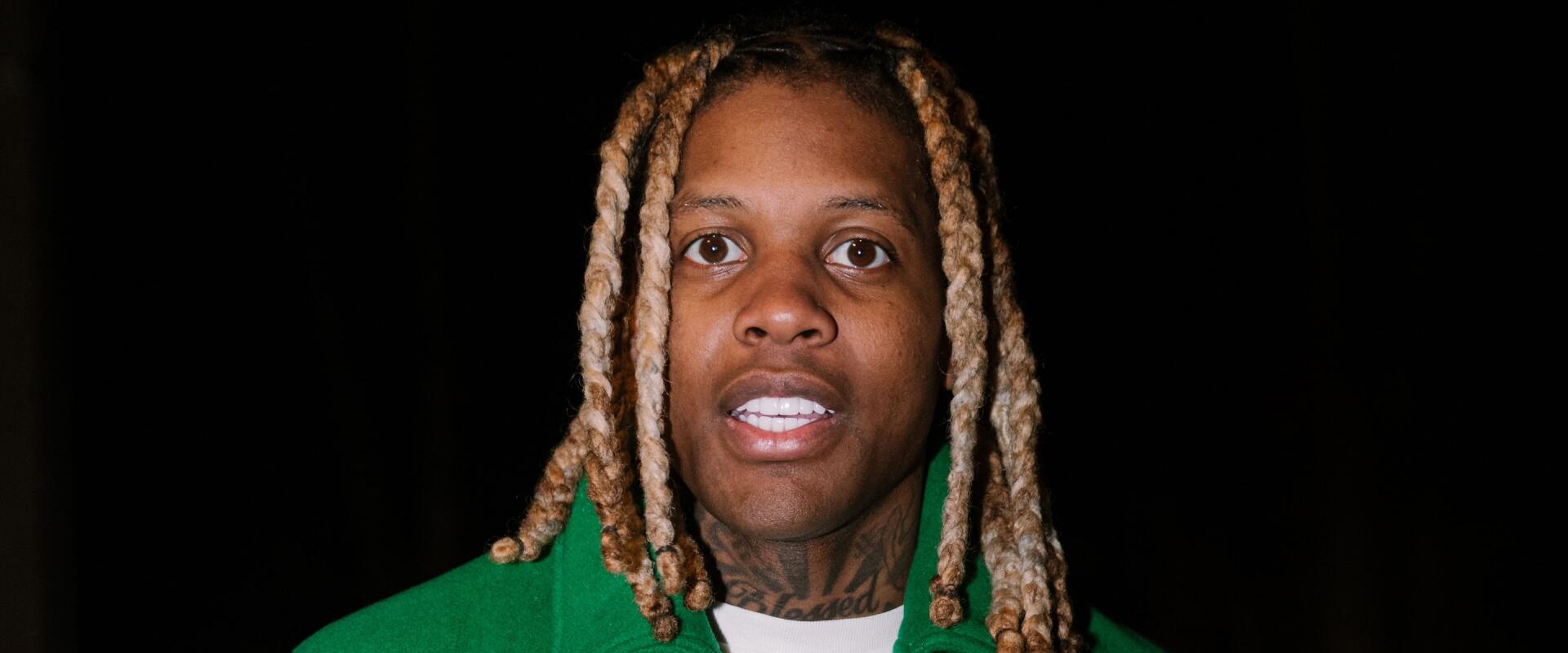 HD desktop wallpaper featuring rapper Lil Durk with blond dreadlocks against a black background, representing music and hip-hop culture.