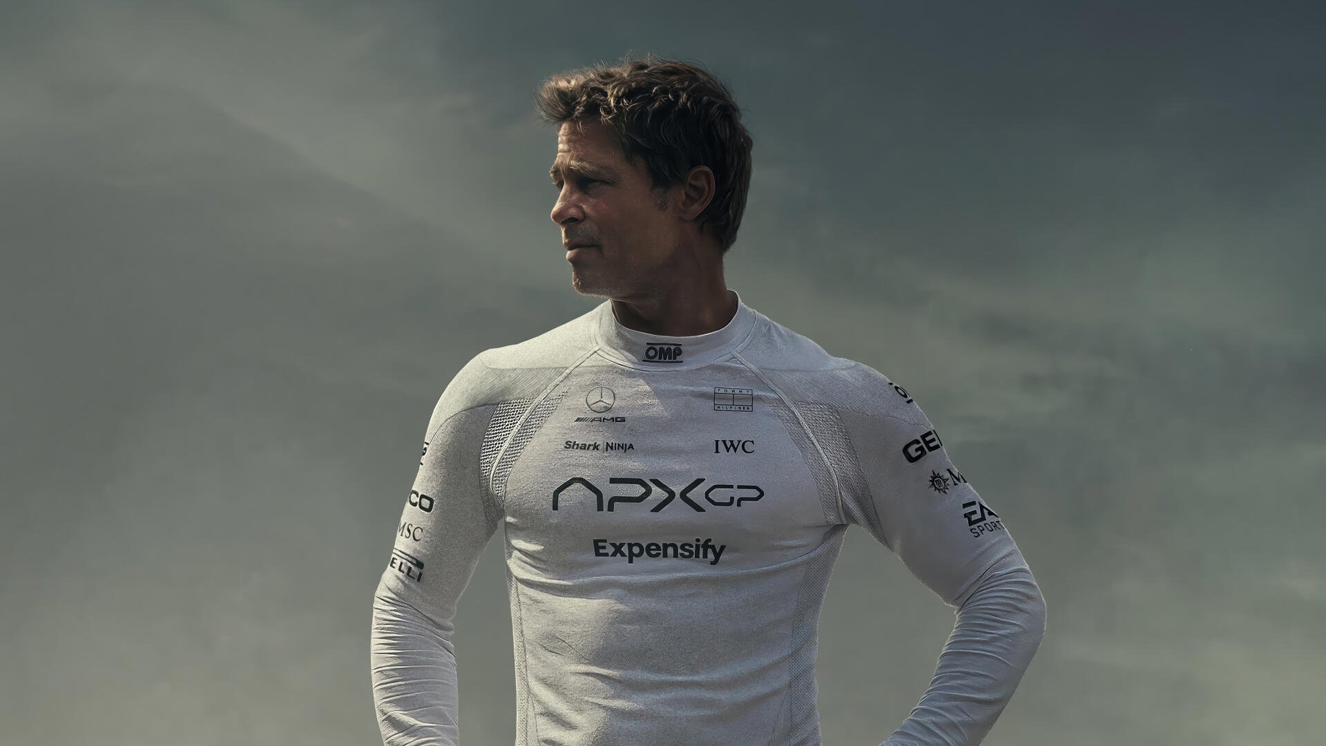 A cinematic 4K Ultra HD wallpaper featuring Brad Pitt in a sleek racing suit, reflecting the excitement of the upcoming F1 movie, set to release in 2025.