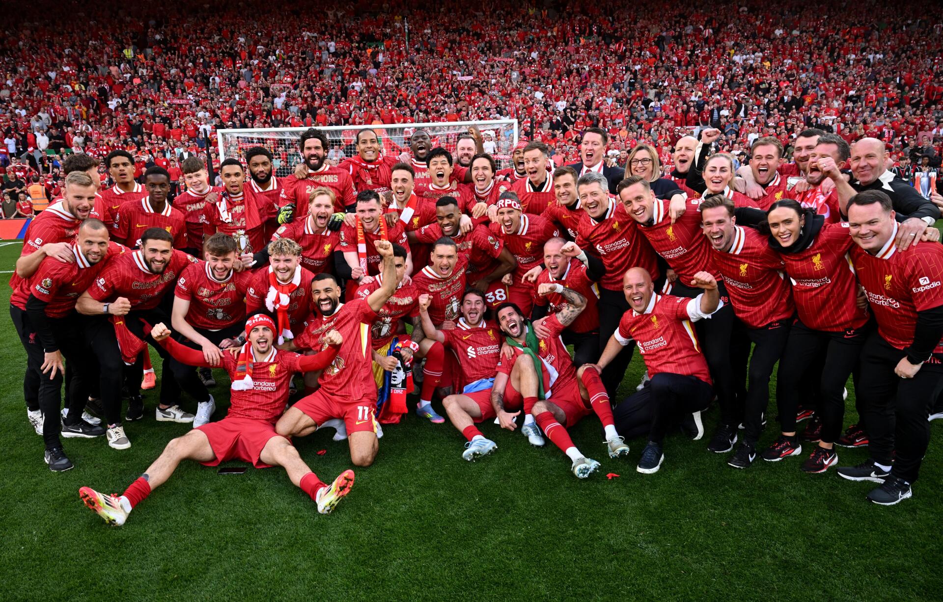 Liverpool F.C. team celebrates on the pitch in a vibrant Premier League 4K Ultra HD soccer wallpaper with fans filling the stadium in the background.