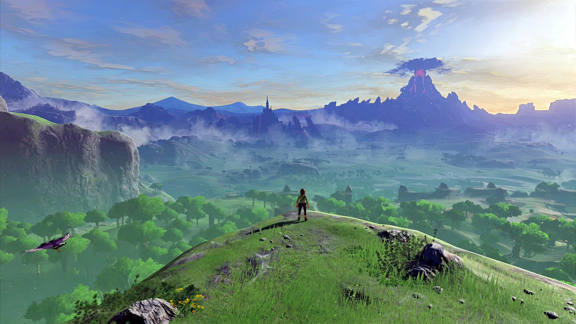 HD PC desktop wallpaper of The Legend of Zelda: Breath of the Wild — Link on a grassy hill overlooking vast Hyrule plains, with a distant volcano and castle at sunrise.