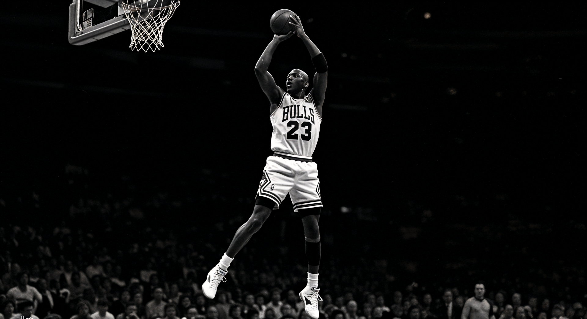 Michael Jordan in mid-air wearing Chicago Bulls jersey, captured in dynamic action on a 4K Ultra HD PC desktop wallpaper and background.