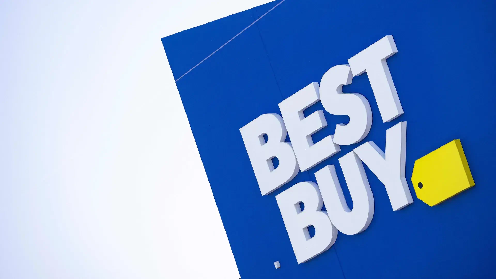 HD wallpaper featuring a close-up of the man-made Best Buy logo against a vibrant blue background.