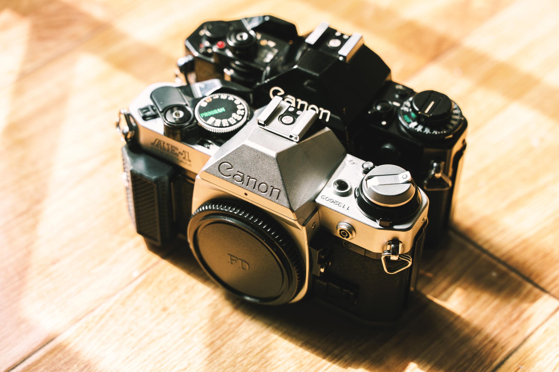 A vintage Canon camera captured in detailed photography, presented as a 4K Ultra HD PC desktop wallpaper and background.