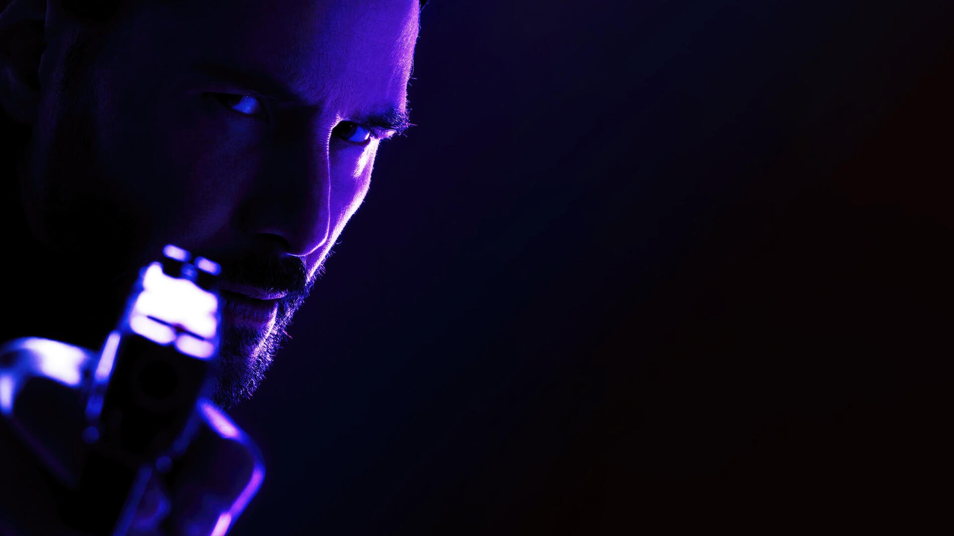Close-up of John Wick holding a gun in a dark, moody setting, captured in striking detail for an 8K Ultra HD PC desktop wallpaper.