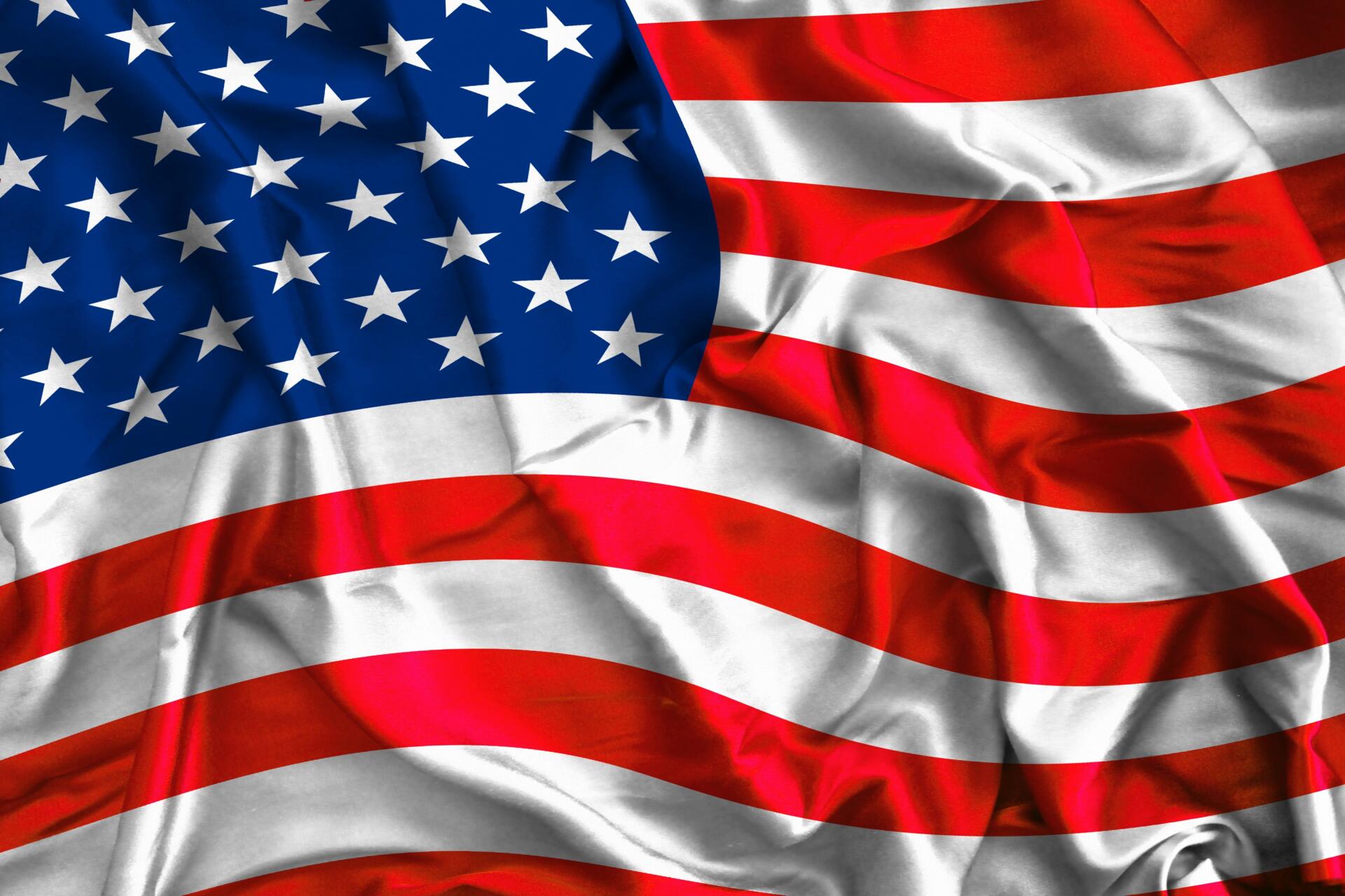 HD desktop wallpaper of the American flag waving, red and white stripes and white stars on blue, themed for the 4th of July and United States celebration.