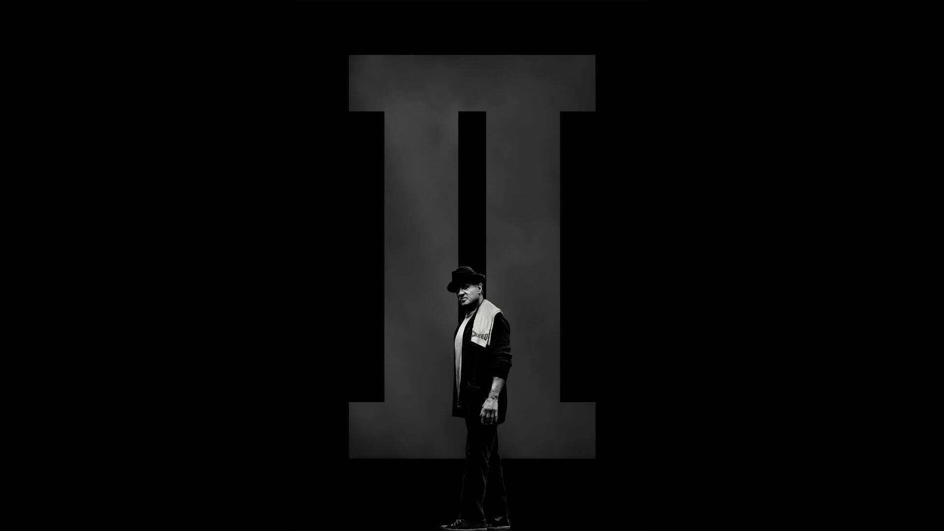 Creed II 4K Ultra HD PC desktop wallpaper: lone fighter in profile stands before a towering Roman numeral II against a stark black background.
