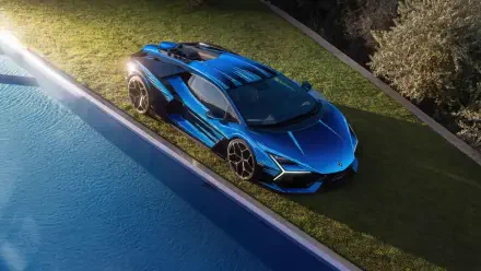 Blue Lamborghini sports car parked on grass by a pool — 4K Ultra HD PC desktop wallpaper/background highlighting sharp angular lines and glossy finish.