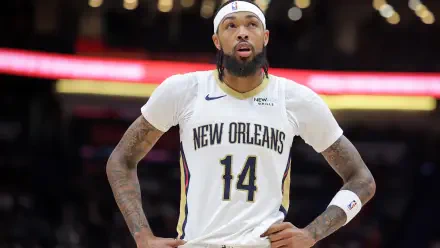 Brandon Ingram of the New Orleans Pelicans stands on the court in his team uniform, focused and ready during an NBA game, showcased in a stunning 4K Ultra HD wallpaper.