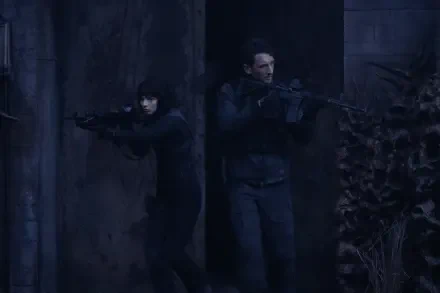 Two characters stealthily move through a shadowy environment, armed with rifles. This tense scene is from the movie *The Gorge* (2025) featuring Miles Teller and Sigourney Weaver.