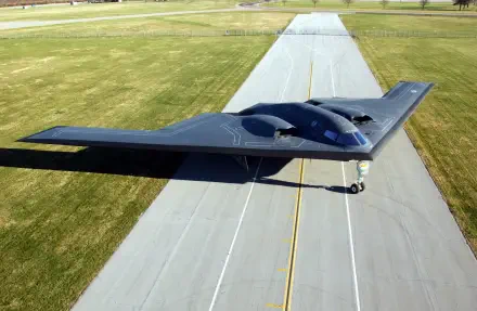 A Northrop Grumman B-2 Spirit aircraft on a runway, showcasing its distinctive stealth design. This image serves as an HD PC desktop wallpaper and background.