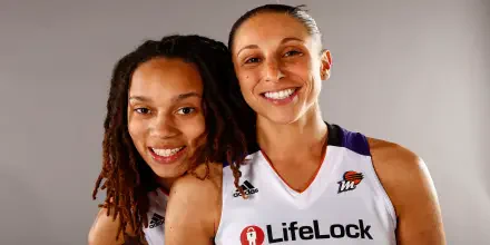 Diana Taurasi and Brittney Griner of the Phoenix Mercury pose together in their WNBA jerseys, showcasing their camaraderie and spirit in this vibrant HD desktop wallpaper.
