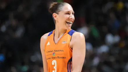 Diana Taurasi smiles during a game, showcasing her energy and skill as a member of the Phoenix Mercury in the WNBA. A vibrant HD wallpaper for basketball fans.