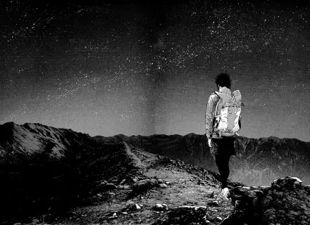 A black-and-white HD wallpaper featuring Mori Buntarou from The Climber, standing on a mountain peak under a starry sky, capturing a sense of adventure and solitude.