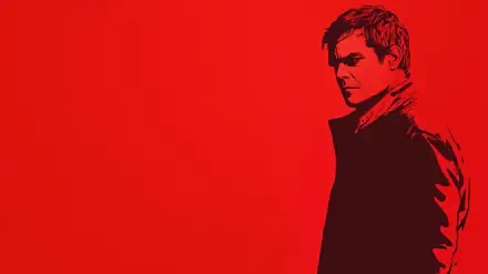 A striking HD wallpaper featuring Michael C. Hall as Dexter, set against a bold red background, capturing the show's intense atmosphere. Perfect for a TV show fan's desktop.