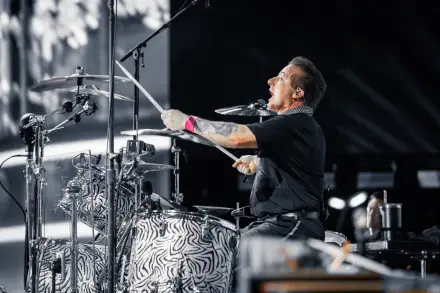 Tré Cool of Green Day passionately plays the drums during a live performance, captured in vibrant detail as part of a 4K Ultra HD desktop wallpaper.