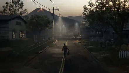 A serene yet eerie scene from The Last of Us Part II, featuring a lone figure walking down a quiet street under dim streetlights, with mountains shrouded in mist in the background.