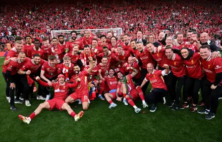 Celebration of Liverpool F.C. players and fans, showcasing a joyful moment on the pitch amidst a sea of red, perfect for a Premier League soccer-themed 4K Ultra HD desktop wallpaper.