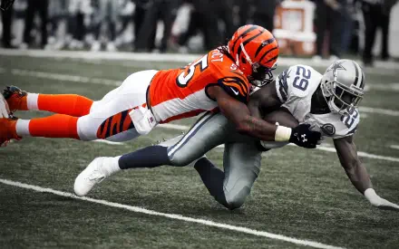 HD PC wallpaper featuring intense NFL action with a Cincinnati Bengals player tackling an opponent during a football game.