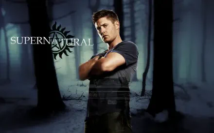 HD PC desktop wallpaper featuring Jensen Ackles as Dean Winchester from the TV show Supernatural, set against a dark, mysterious forest background.