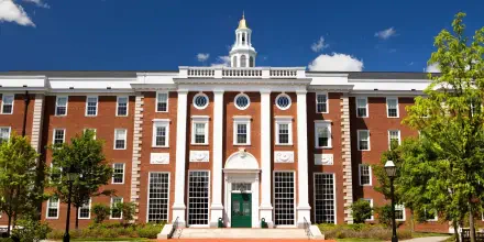 HD desktop wallpaper featuring the classic Georgian architecture of Harvard University in Cambridge under a clear blue sky.