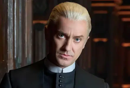 HD movie wallpaper of Draco Malfoy, portrayed by Tom Felton in the Harry Potter series, featuring his iconic platinum blonde hair and intense gaze.