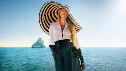 4K Ultra HD wallpaper featuring Blake Lively from the movie Another Simple Favor, standing by the sea with a large striped hat and elegant outfit.