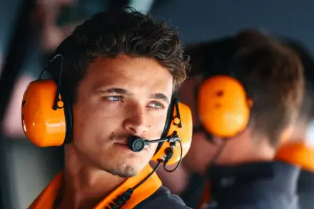 Close-up of F1 driver Lando Norris wearing a headset, captured in an HD PC desktop wallpaper and background.