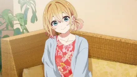 Anime HD PC desktop wallpaper: Mami Nanami (Rent-A-Girlfriend) smiling on a wicker sofa, wearing a floral dress and light cardigan, soft indoor lighting and a potted plant behind her.