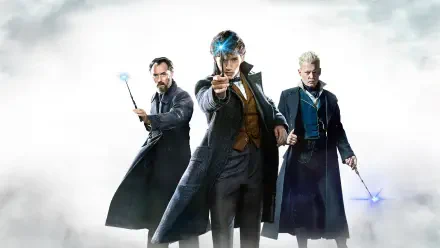 HD PC desktop wallpaper for Fantastic Beasts: The Crimes of Grindelwald — three wizards in long coats aim glowing wands forward against a misty, dramatic white-gray backdrop.