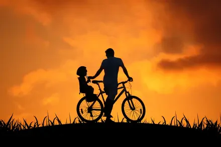 HD PC desktop wallpaper background: family silhouette of a parent and child on a bicycle against an orange sunset.