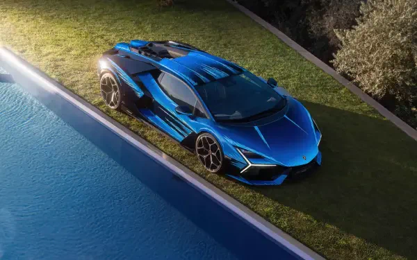 Blue Lamborghini sports car parked on grass by a pool — 4K Ultra HD PC desktop wallpaper/background highlighting sharp angular lines and glossy finish.