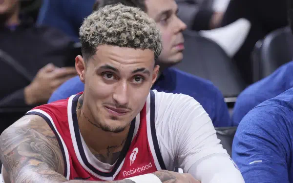 Kyle Kuzma of the Washington Wizards, captured during a game, showcases his confident smile in this HD basketball wallpaper. A vibrant moment from the NBA season.