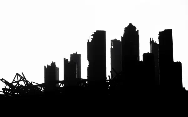 A haunting post-apocalyptic city silhouette, featuring crumbling skyscrapers against a stark white background. This 4K Ultra HD image serves as a striking desktop wallpaper.