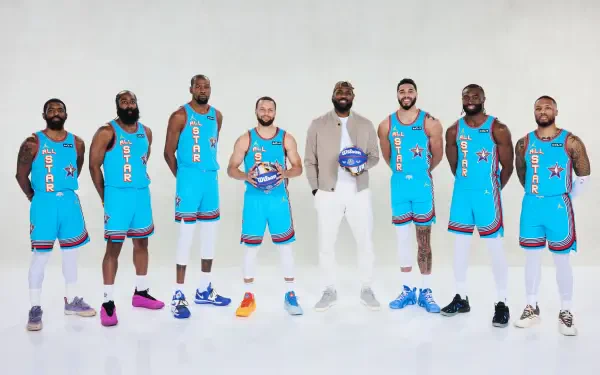 A group of NBA All-Star players, including Stephen Curry and LeBron James, poses in vibrant blue jerseys, showcasing their camaraderie and competitive spirit in a high-quality wallpaper image.