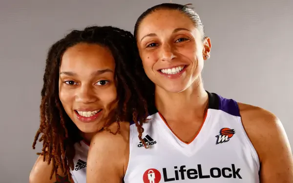 Diana Taurasi and Brittney Griner of the Phoenix Mercury pose together in their WNBA jerseys, showcasing their camaraderie and spirit in this vibrant HD desktop wallpaper.