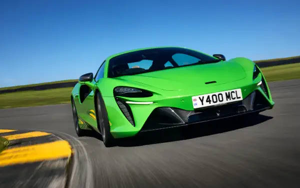 A vibrant green McLaren Artura racing on a track, showcased in stunning 8K Ultra HD, captures the essence of performance and luxury.