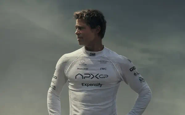 A cinematic 4K Ultra HD wallpaper featuring Brad Pitt in a sleek racing suit, reflecting the excitement of the upcoming F1 movie, set to release in 2025.